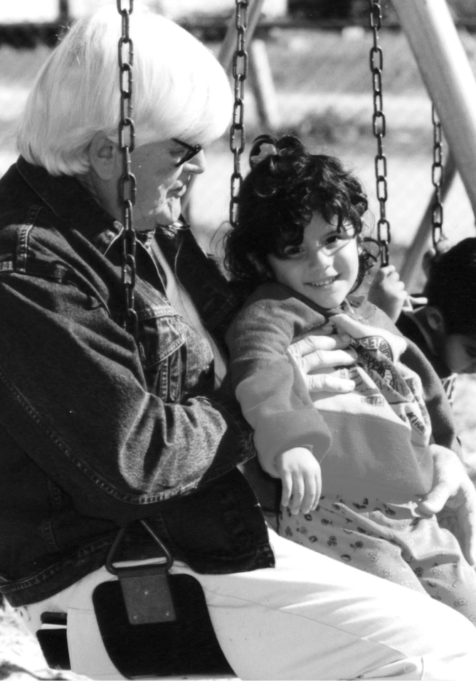 Photo of Wendell Rollason in a swing with a kid